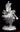 Back view of, "Little Fancy Dancer," paper sculpture by Patty Eckman featuring a young Native American dancing in full regalia.